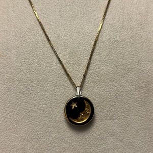 Black and gold, celestial moon and star pendant on gold chain.